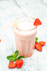 Two Glass with tasty strawberry smoothie with berries and yogurt in glass jar on white background. Vegetarian healthy drink