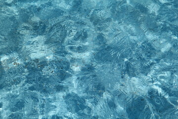 blue pool water background photo with caustics in sunny day