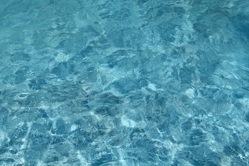 blue pool water background photo with caustics in sunny day