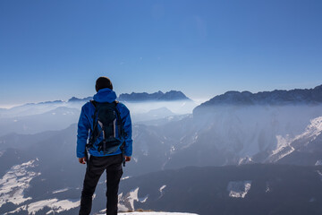 Man enjoying panoramic view from summit Freiberg of Karawanks, Julian Alps, in Carinthia, Austria....