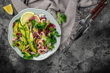Healthy seafood salad with shrimps, avocado slices and fresh greens, Healthy food. superfood concept. clean eating concept. Vegan or gluten free diet, top view. place for text
