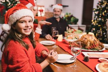 Merry Christmas! Happy family are having dinner at home. Celebration holiday and togetherness near tree