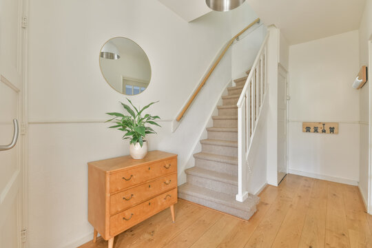 Corridor of residential house with staircase and wooden floor