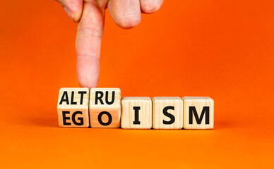 Altruism or egoism symbol. Concept words Egoism and Altruism on wooden cubes. Psychologist hand....