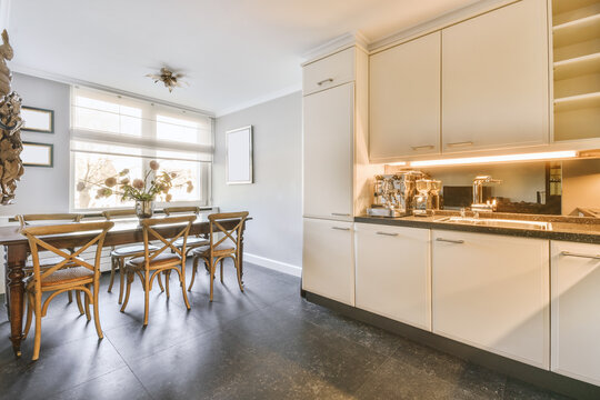 White furniture and appliances in spacious kitchen with dining zone