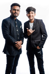 Brothers in different poses wearing blazers or traditional wear during the festival