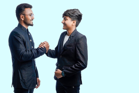 Portrait Of A Two Confident Indian Men Shaking Hands Isolated Over White Background