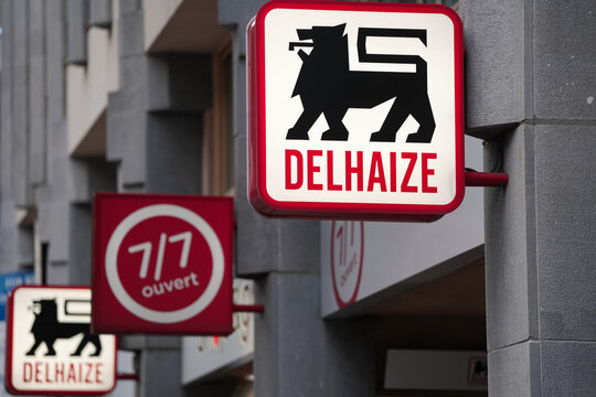 The logo sign of Delhaize grocery store on top of a store from Brussels, Belgium, 2022.