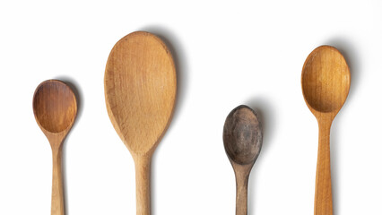 Wooden kitchen utensils and spoons isolated on white background