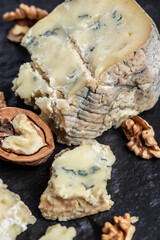 Blue cheese with pears, walnuts, nuts and honey. French cuisine. Vegetarian lunch. vertical image. top view. place for text