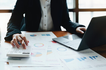 Accountants, Asian auditors are using calculators and computers to review annual tax budgets to submit information to the IRS.