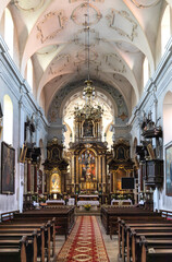 Main nave and presbytery of Holy Mary of Mirow sanctuary within Franciscan monastery in historic old town quarter of Pinczow in Poland