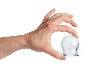 A hand holds a cupping therapy cap with index finger and thumb, isolated on white.