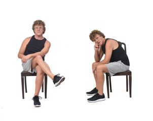 Obraz na płótnie Canvas side and front view of same man with sportswear sitting on chair on white background