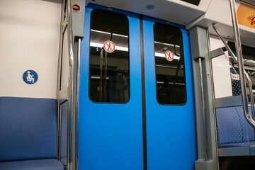 The doors in the subway car are blue