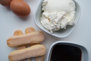 

Ingredients for cooking tiramisu - Savoiardi biscuit cookies, mascarpone, cream, sugar, coffee,egg.
