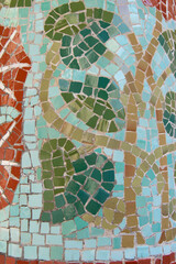 mosaic of ceramic tesserae in a column formed by a branch with leaves