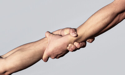 Helping hand concept, support. A friendly handshake. Two hands, shaking hands. Rescue, helping gesture or hands. Close up help hand. Two hands, helping arm of a friend, teamwork - Powered by Adobe