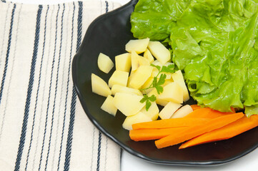 Beautiful salad dish with potato, carrot and lettuce