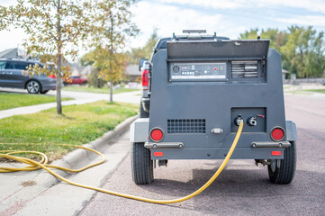 Winterizing a residential irrigation system by using a compressor and forced air to blow the lines empty. - obrazy, fototapety, plakaty