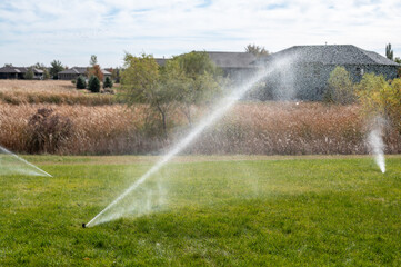 winterizing a irrigation sprinkler system by blowing pressurized air through to clear out water - obrazy, fototapety, plakaty