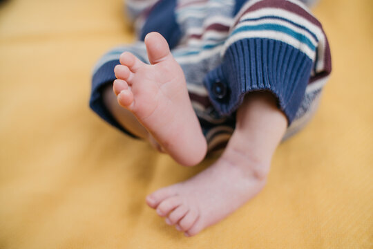 two week old very cute baby in overalls on an orange plaid. High quality photo