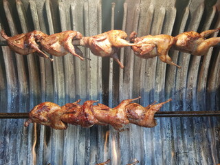 Tasty grilled chickens on a split
