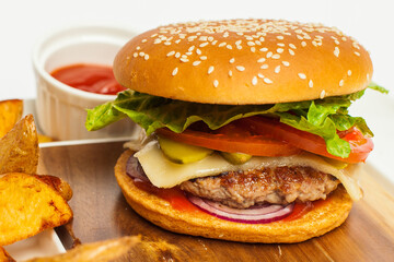 Craft beef burger and french fries on wooden table