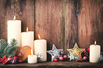 Christmas Advent candles with festive decor.