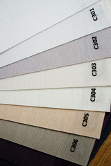 Samples of textured fabrics of different colors for the manufacture of fabric blinds for sun...