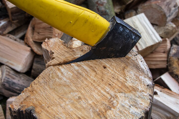 An ax and a stump while chopping firewood on a clear day. Heating.