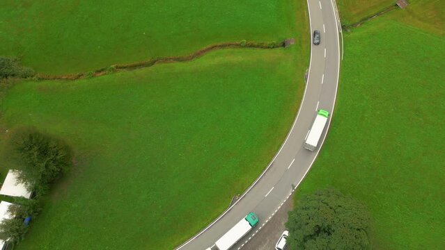 Landing aerial shot of very busy contry road road in Swiss alps near Innertkirchen