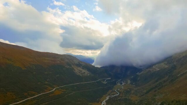 Timelapse View at Goms valley, Rotten river and rolling clouds going from behind the mountain