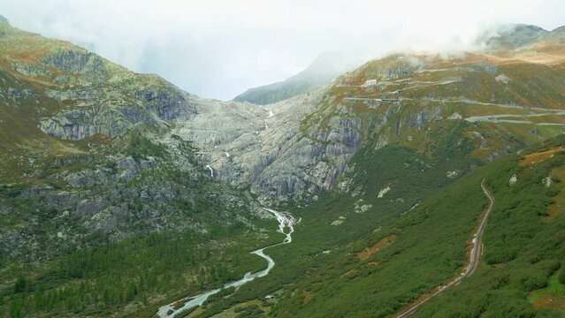 Aerial view of valley and waterfall from melted glacier Rhonegletscher