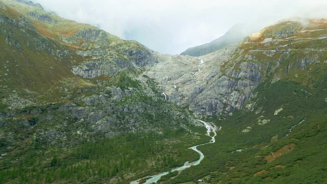 Aerial view of valley and waterfall from melted glacier Rhonegletscher