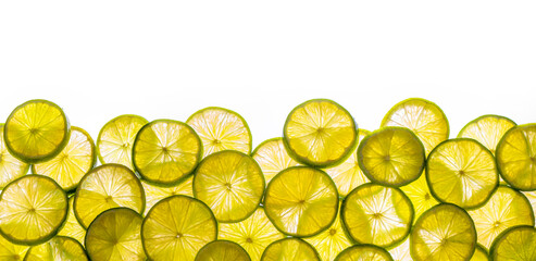 a bunch of shiny lime slices isolated on a white background for banner, border, panorama