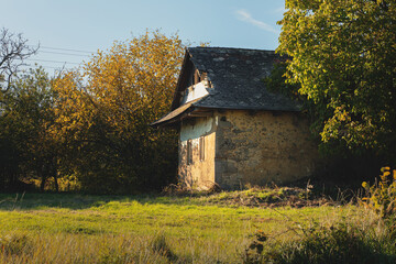 Plakat Old peasant house in beautiful natural surroundings.Sunny day in autumn.
