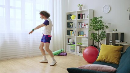 Funny young man dancing after training, good mood, active lifestyle, humor