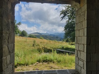 Frame: view out of a window onto the greek mountains near metsovo in northern greece