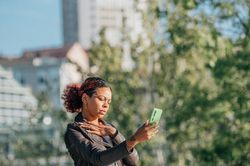 black latin american girl outdoors taking photo or recording