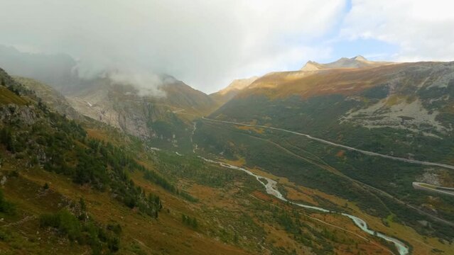 Timelapse View at Goms valley, Rotten river and rolling clouds going from behind the mountain