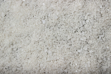 Coarse rock salt in full screen as a background for the image. Rock salt texture
