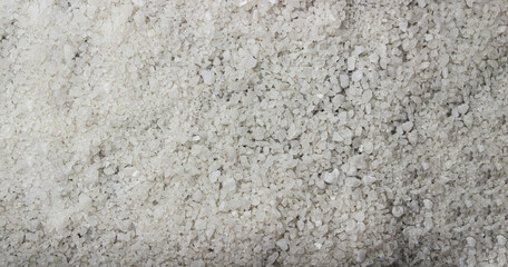 Coarse rock salt in full screen as a background for the image. Rock salt texture