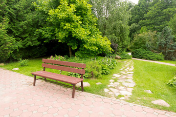 bench for rest in the park near the path