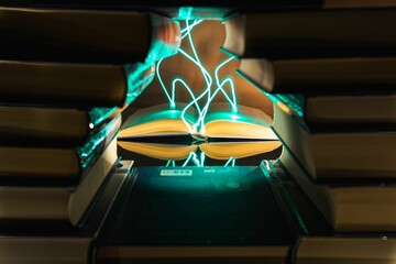 Open book in the library and lightning coming out of the book