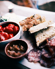 A focaccia focussed close up of a charcuterie board by the window light.