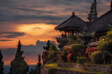 Pura Besakih old temple with thatched roof from high viewpoint on horizon during sunset as Bali travel lifestyle