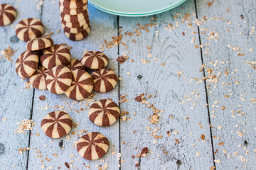 Sweet chocolate brownies on rustic wooden table with flakes