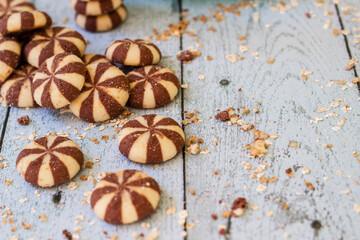 Sweet chocolate brownies on rustic wooden table with flakes