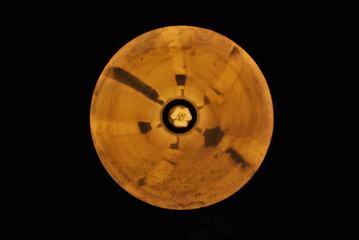 an amazing round lamp shade emitting orange light